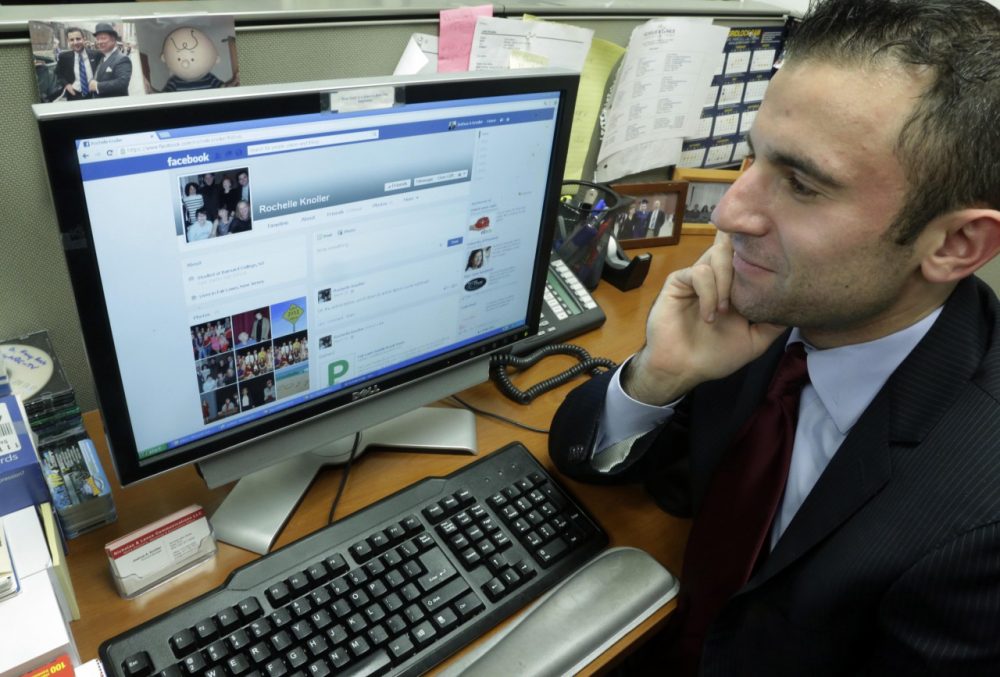 Joshua Knoller looks at the Facebook page of his mother, Rochelle. (AP/Richard Drew)