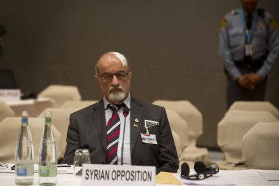 Haitham al-Maleh, senior member of the Syrian National Coalition (SNC), Syria's main political opposition group, sits alone at the opposition table during the first day of the Syrian peace talks in Montreux, Switzerland, Wednesday, Jan. 22, 2014. The Syrian peace talks begin with a bitter clash over President Bashar Assad's future. U.S. Secretary of State John Kerry says Assad's decision to meet peaceful dissent with brutal force had robbed him of all legitimacy, while Assad's foreign minister declared that no one outside Syria had the right to remove the government. (AP)