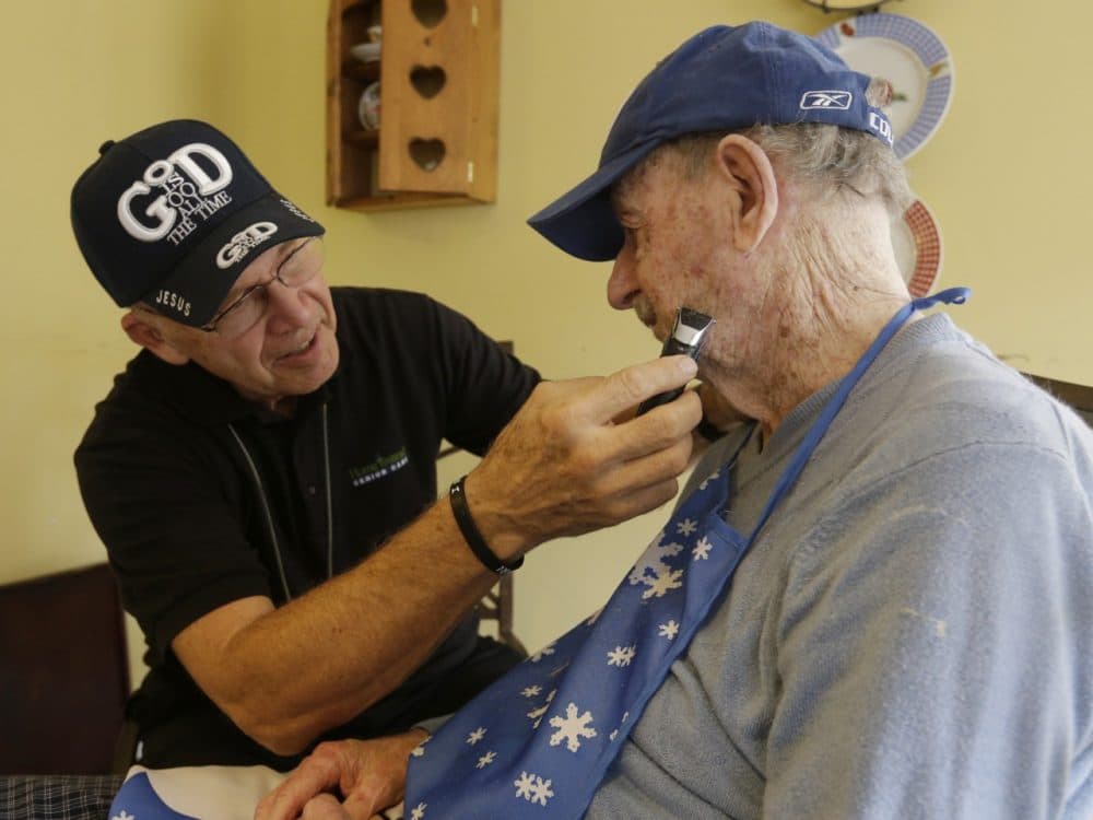 Caregiver Warren Manchess shaves Paul Gregoline, in Noblesville, Ind. (Darron Cummings/AP)