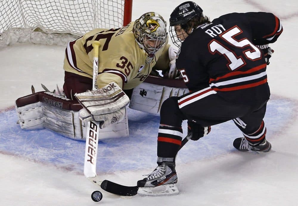 Boston College goalie Parker Milner, left, makes a stick save on a shot by Northeastern forward Kevin Roy during the third period of the championship game at the Beanpot tournament in Boston, Monday, Feb. 11, 2013. (AP/Charles Krupa)