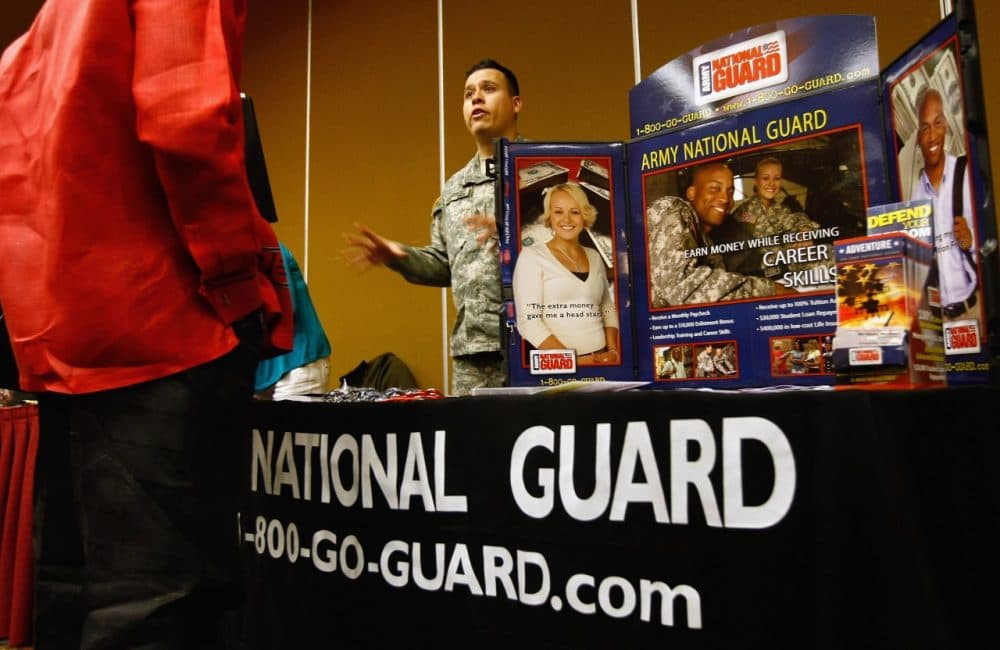 A National Guard recruiter speaks to a potential soldier at a career fair December 8, 2009 in Denver, Colorado. (John Moore/Getty Images)
