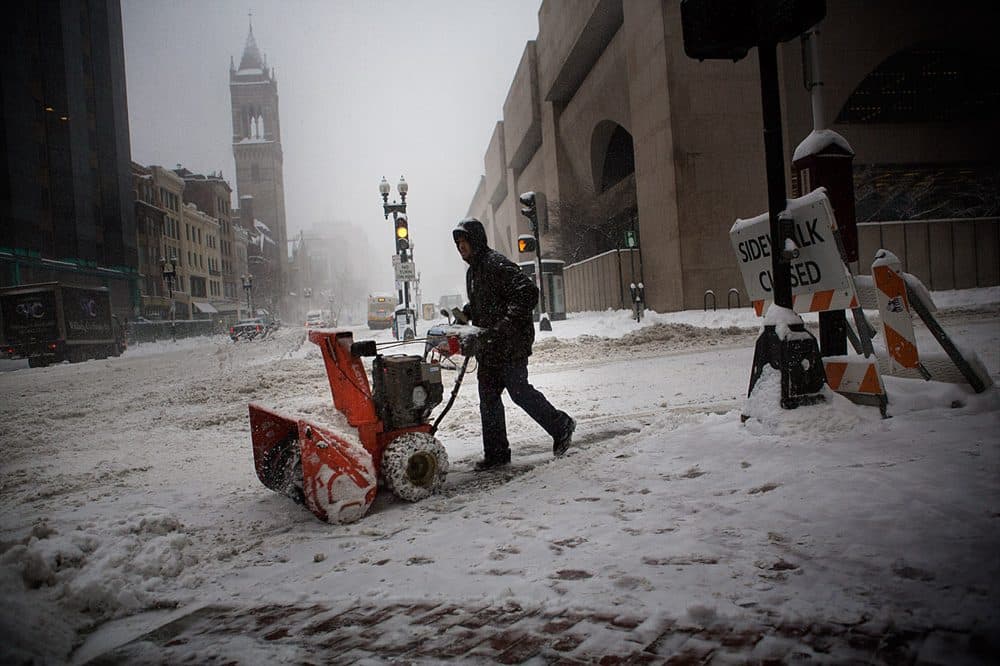 A snow plow operator works in front of Boston's Lenox Hotel Wednesday morning. (Jesse Costa/WBUR)