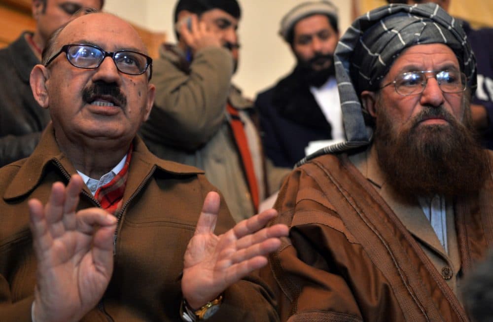 Tehreek-e-Taliban Pakistan committee member and senior religious party leader Maulana Sami-ul-Haq (right) looks on as Special Assistant to Pakistan's prime minister Irfan Siddiqui (left) speaks during a joint press conference following their meeting at the Khyber Pakhtunkhwa House in Islamabad on February 6, 2014. (Aamir Qureshi/AFP/Getty Images)
