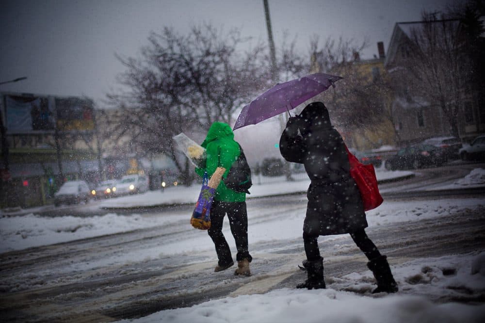 Two women walk through Hyde Square in Boston's Jamaica Plain early Thursday afternoon. (Jesse Costa/WBUR)