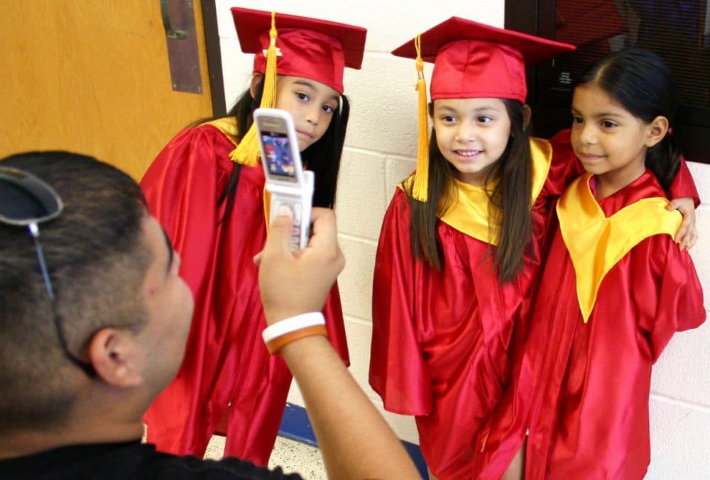 David Gonzales takes a photo of Denycia Rubio, Haley Santana Gonzales and Jackie Guillen before their graduation from a headstart graduation ceremony for four-year-old pre-K students. (Lynn Hermosa/AP)