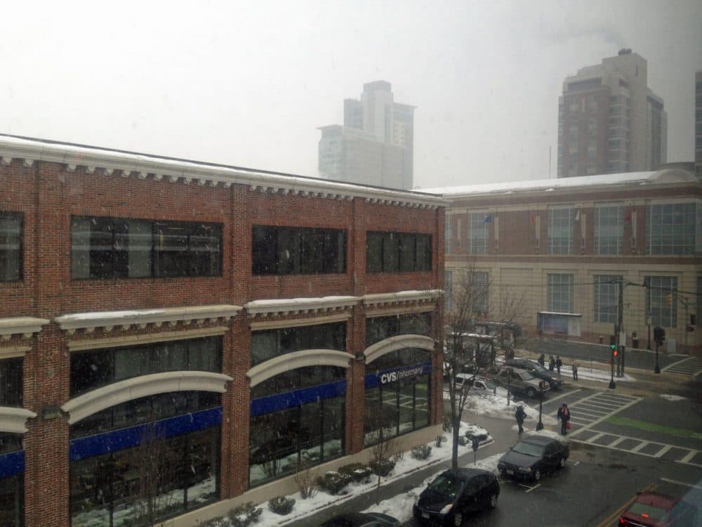Swirling snowflakes are just beginning to fall on the streets of Boston. (Alexandra Koktsidis/WBUR)