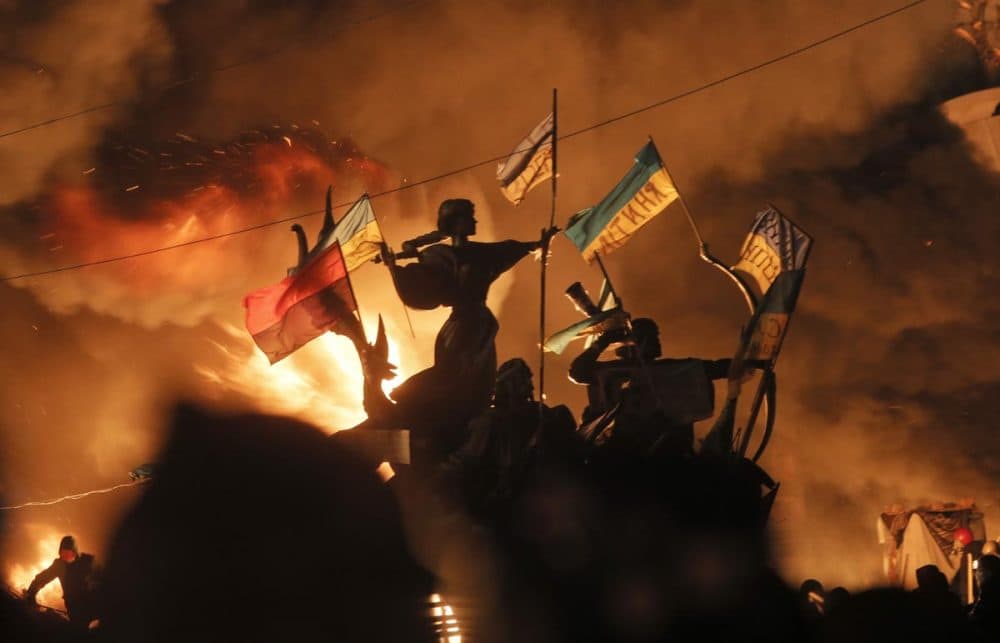 Monuments to Kiev's founders burn as anti-government protesters clash with riot police in Kiev's Independence Square, the epicenter of the country's current unrest, on Tuesday. (Efrem Lukatsky/AP)