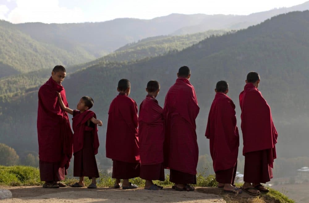 Bhutanese novice Buddhist monks stand outside a monastery in the capital of Thimphu, Bhutan. (Kevin Frayer/AP)