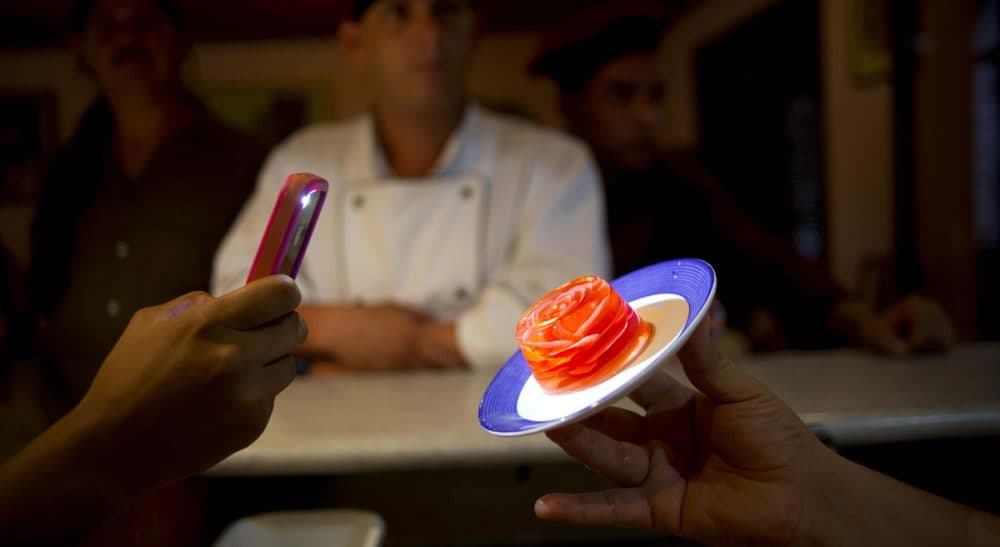 Remember when food was just something you ate? In this Oct 18, 2013 photo, a chef holds up a 3D gelatin flower dessert in Havana, Cuba. (Ramon Espinosa/AP)