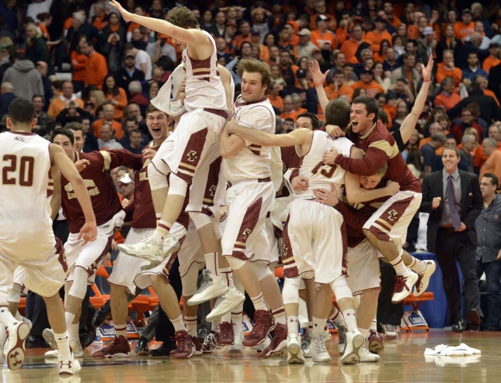 Boston College players celebrate after defeating Syracuse 62-59 in overtime . (Kevin Rivoli/AP)