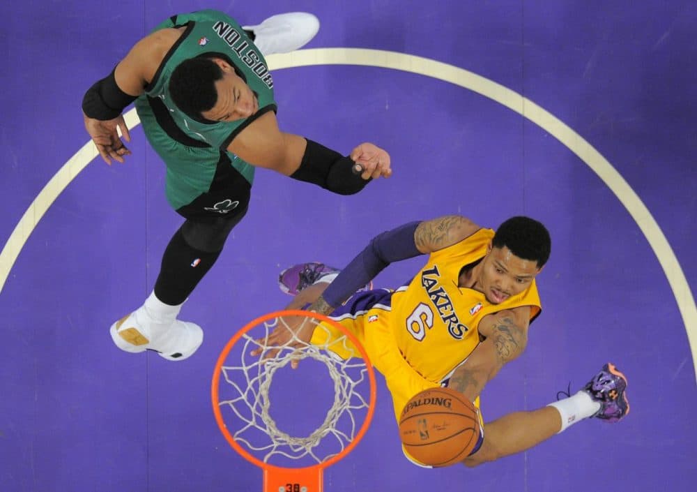 Los Angeles Lakers guard Kent Bazemore, right, goes up for a shot as Boston Celtics center Jared Sullinger defends during the first half of an NBA basketball game in Los Angeles. (Mark J. Terrill/AP)