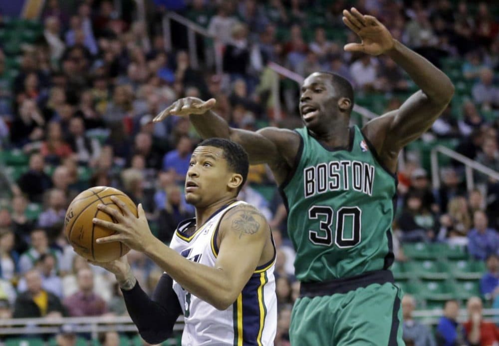 Utah Jazz's Trey Burke, left, goes to the basket as Boston Celtics' Brandon Bass (30).(AP/Rick Bowmer)