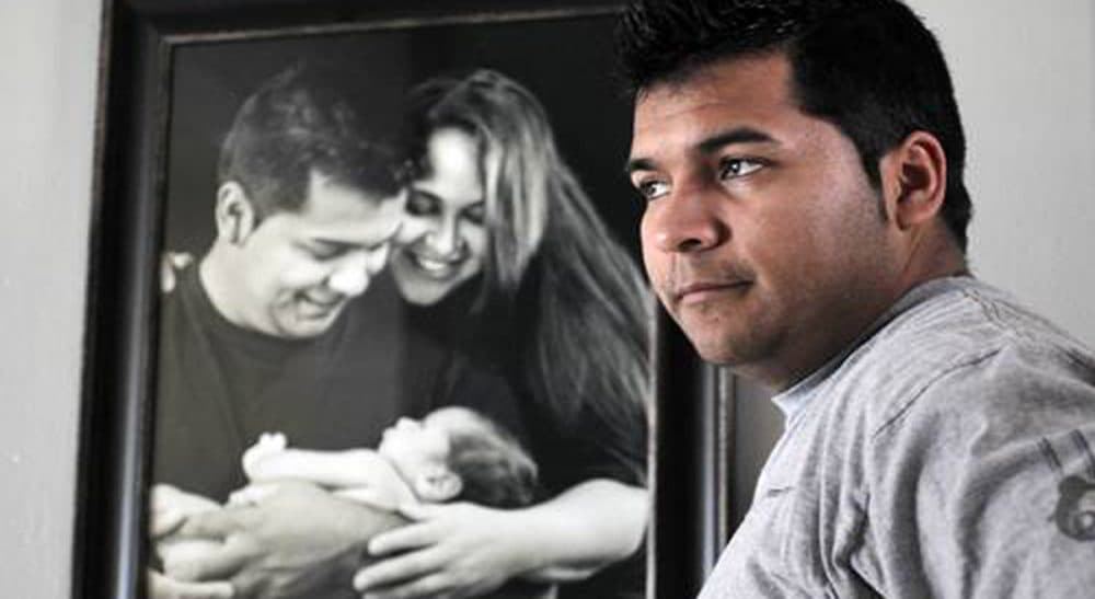 Marlise Munoz is gone -- but the thorny questions she helped raise live on. In this photo, Erick Munoz stands before a photo of him and his wife, Marlise, after the birth of their first son, Mateo. (AP)
