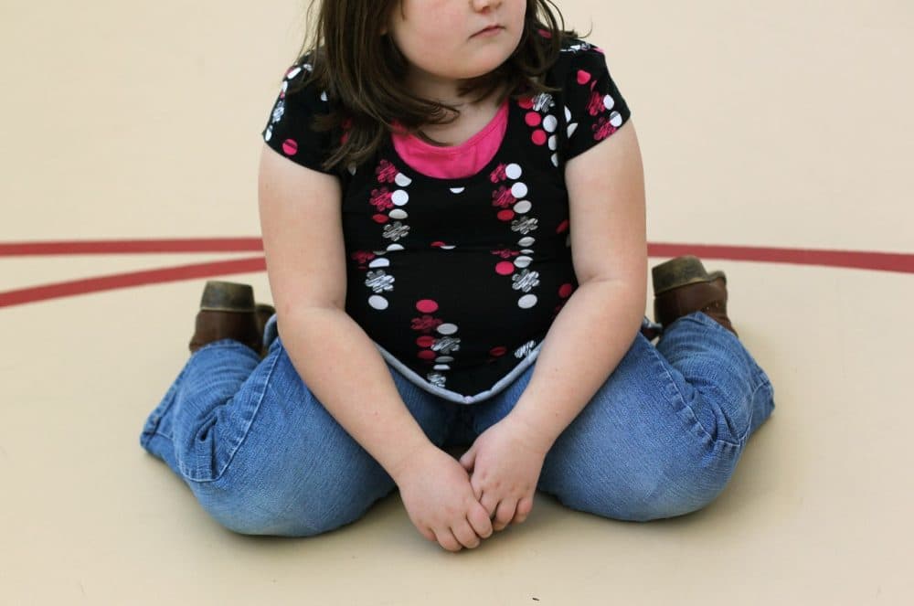 A child sits on the gym floor during the Shapedown program for overweight adolescents and children on November 13, 2010 in Aurora, Colorado. (John Moore/Getty Images)