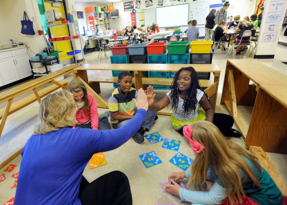 Third-grade teacher Sherry Frangia, left, high-fives student Jayla Hopkins during a math lesson at Silver Lake Elementary School in Middletown, Del. Tuesday, Oct. 1, 2013. Silver Lake has begun implementing the national Common Core State Standards for academics. (AP)
