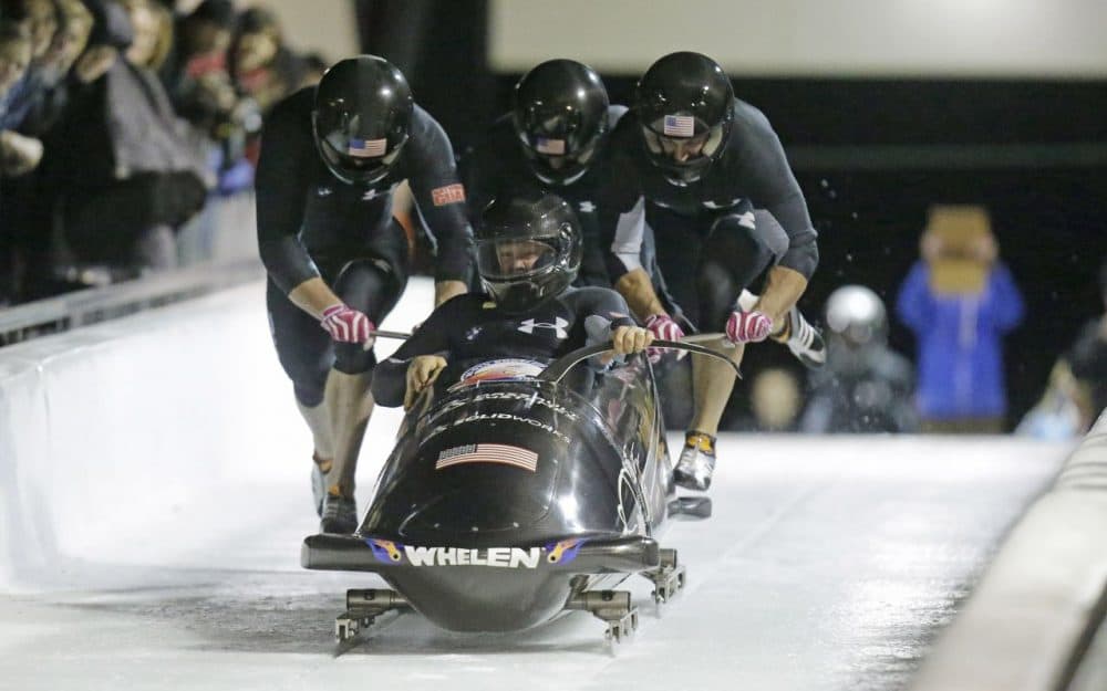 From front to back, Steve Holcomb, Curt Tomasevicz, Steve Langton, Chris Fogt climb in to their sled during the United States four-man bobsled team trials Friday, Oct. 25, 2013, in Park City, Utah. (Rick Bowmer/AP)