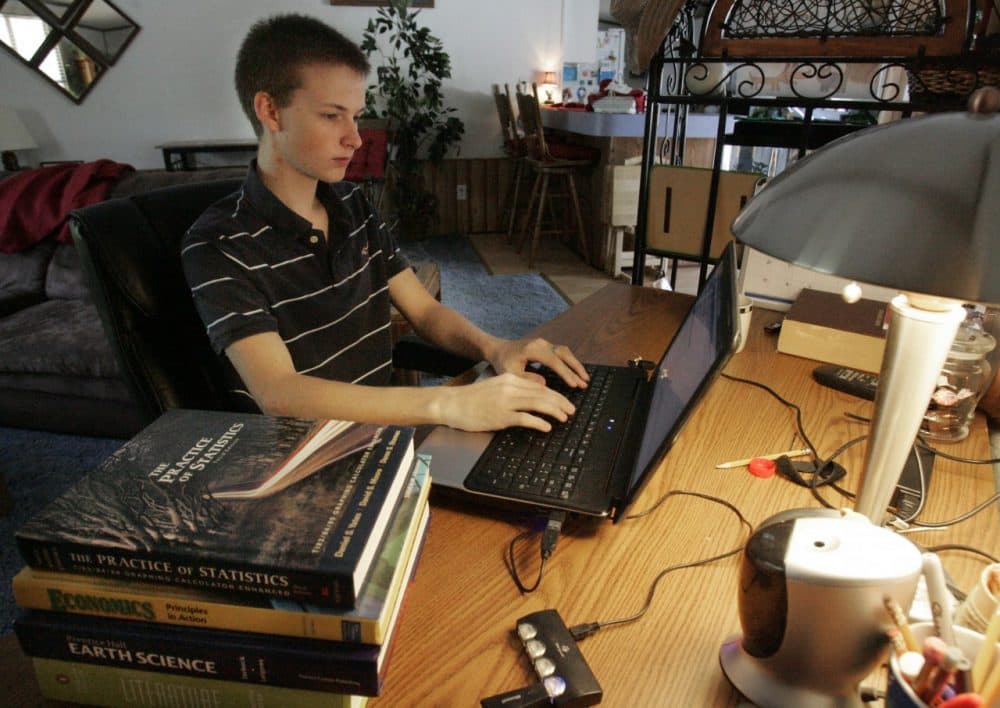 Jared Dennis, 18, logs onto his school website in his home in Lexington, S.C. (AP/Mary Ann Chastain)