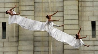 Aerial dancers rehearse while suspended on ropes on the wall of the Old Post Office Pavilion, home to the National Endowment for the Arts in Washington, on Wednesday, May 9, 2012. (Jacquelyn Martin/AP)