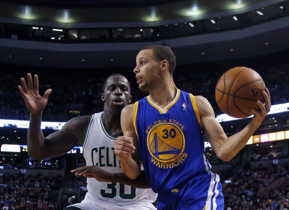 Golden State Warriors point guard Stephen Curry (30) controls the ball against Boston Celtics forward Brandon Bass (30). (AP/Elise Amendola)