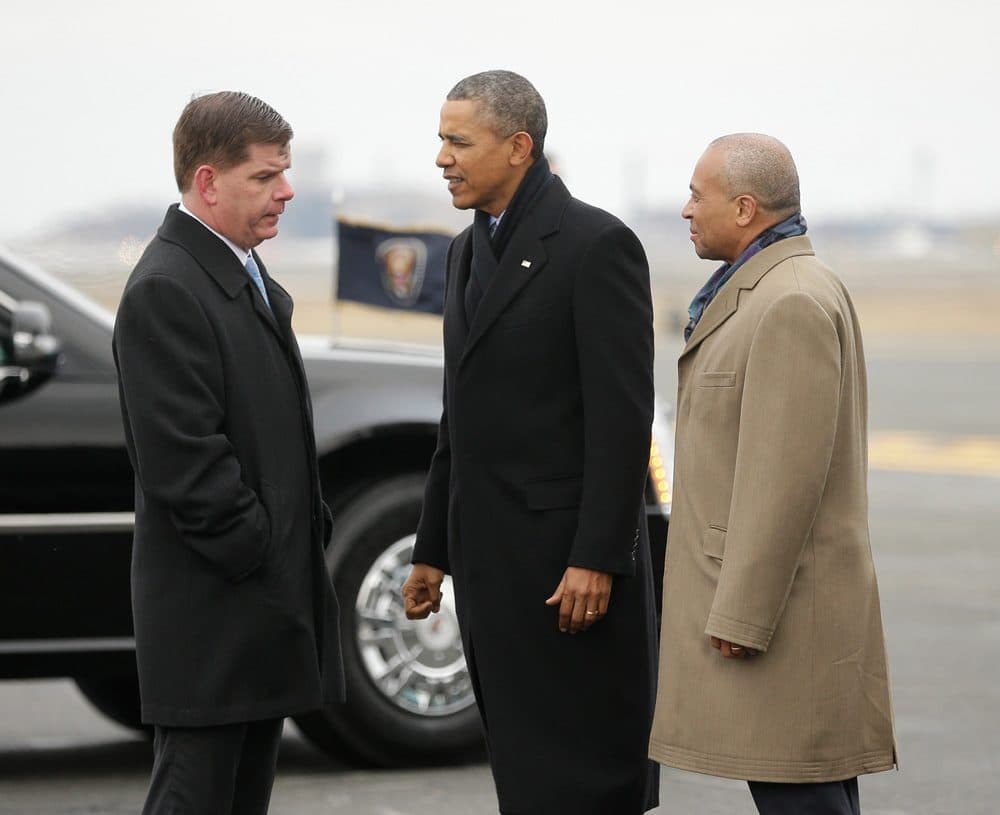 After his arrival at Logan Airport Wednesday afternoon, President Obama talks with Boston Mayor Mayor Martin Walsh, as Gov. Deval Patrick looks on. (Pablo Martinez Monsivais/AP)
