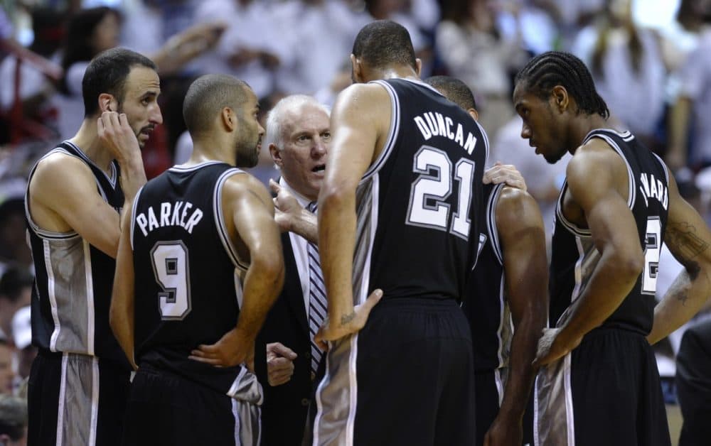 Is Coach Popovich sharing words of wisdom with his team or telling them 'I got nothing for you?' (BRENDAN SMIALOWSKI/AFP/Getty Images)