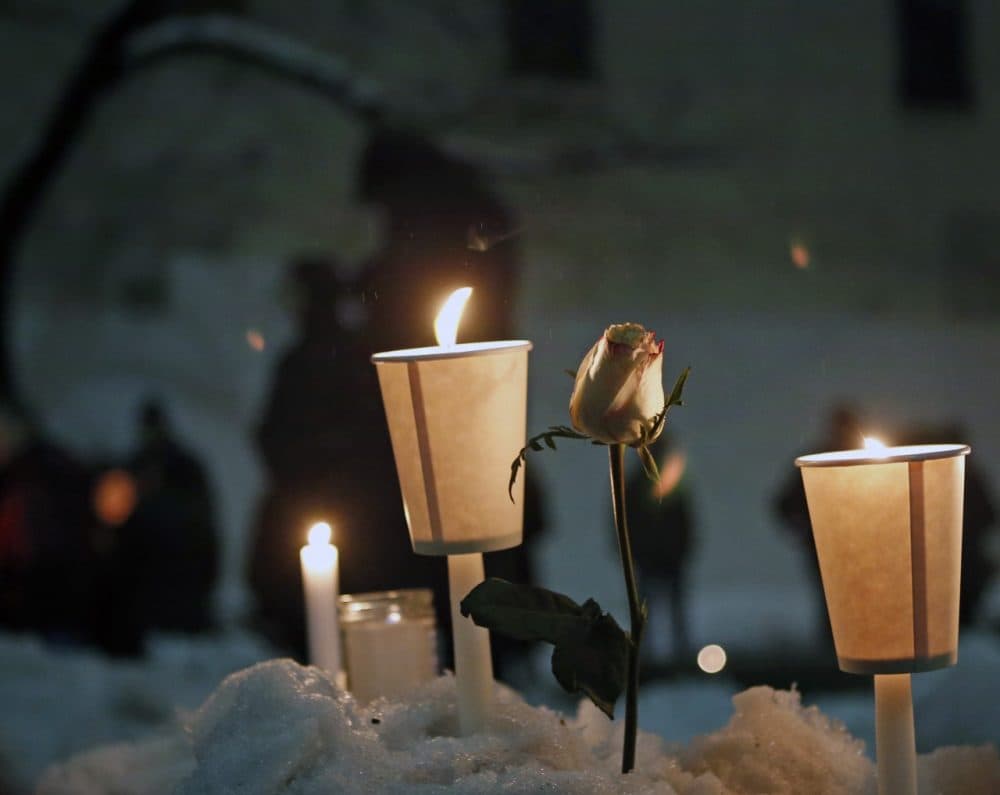 Candles burn alongside a rose left in a snowbank following a candlelight vigil for actor Philip Seymour Hoffman, who died of a drug overdose. (Kathy Willens/AP)