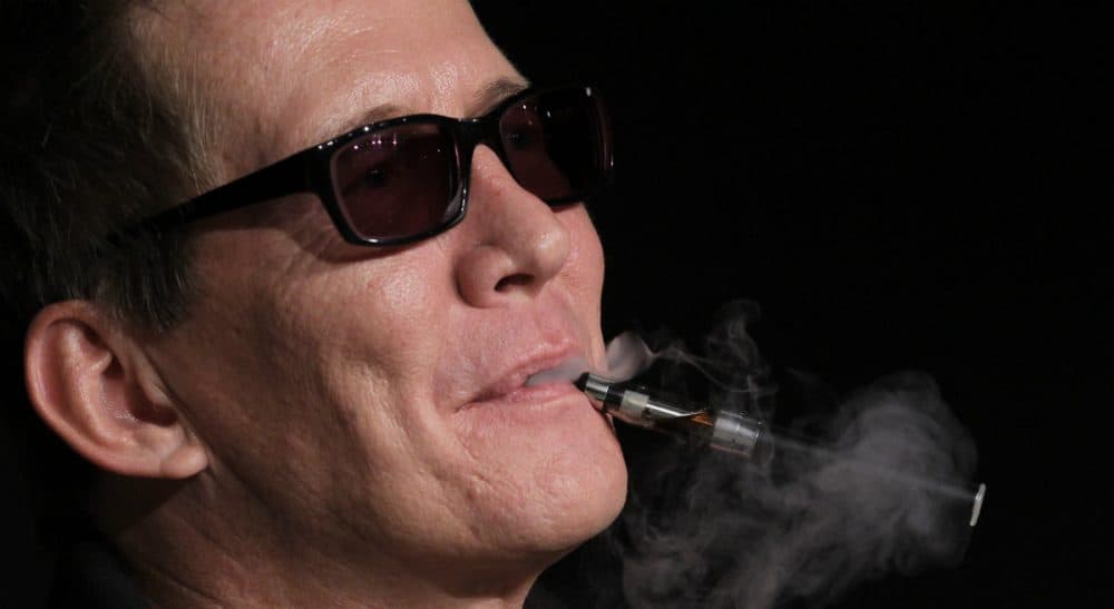 In this photo, Actor Thomas Bo Larsen smokes an electronic cigarette during a press conference for The Hunt at the 65th international film festival, in Cannes, France, Sunday, May 20, 2012. (Francois Mori/AP)