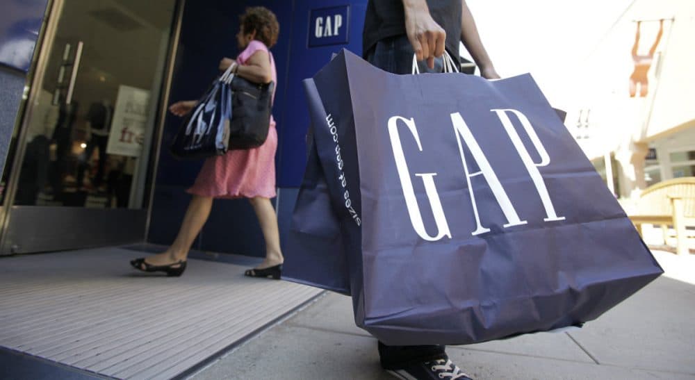 In this Aug. 9, 2009, file photo, a shopper leaves a Gap store in Palo Alto, Calif. The nation’s largest clothing chain, which operates, Gap, Old Navy, Banana Republic and Athleta, said it would raise the wages to $10 by 2015. (Paul Sakuma/AP)