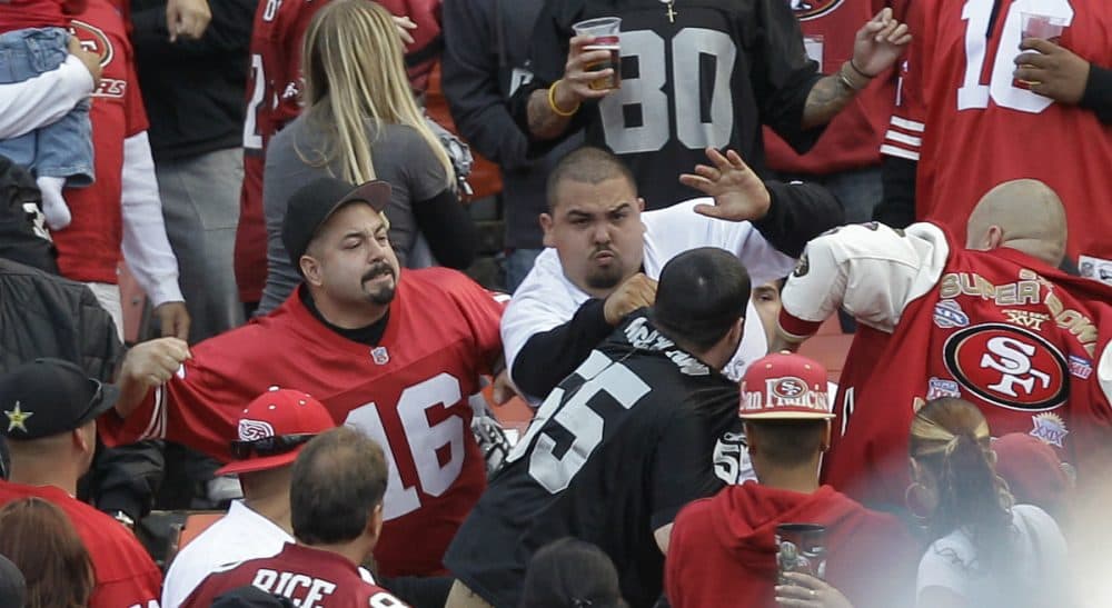 In this Aug. 20, 2011 photo, football fans fight in the stands during a preseason NFL football game between the San Francisco 49ers and the Oakland Raiders in San Francisco. (Ben Margot/AP)