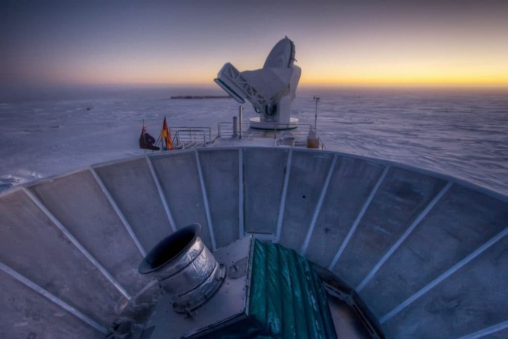 In this 2007 photo, the sun sets behind the BICEP2 telescope, foreground, and the South Pole Telescope in Antarctica. (Steffen Richter/AP)
