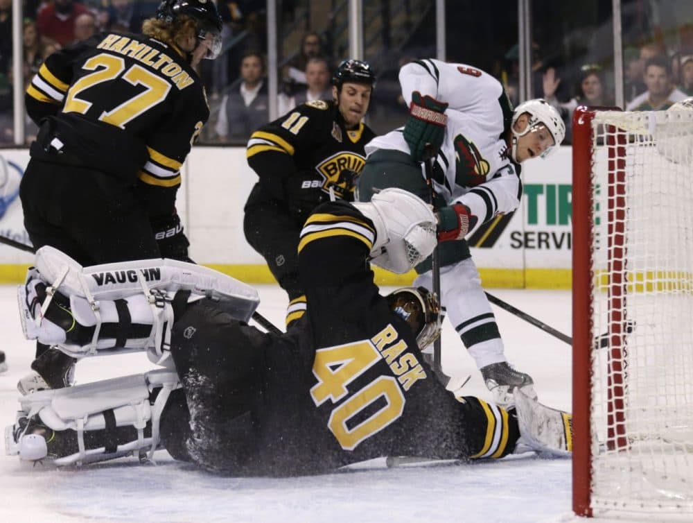 Boston Bruins goalie Tuukka Rask (40) drops to the ice to make a save on a shot by Minnesota Wild center Mikko Koivu (9). (AP/Charles Krupa)