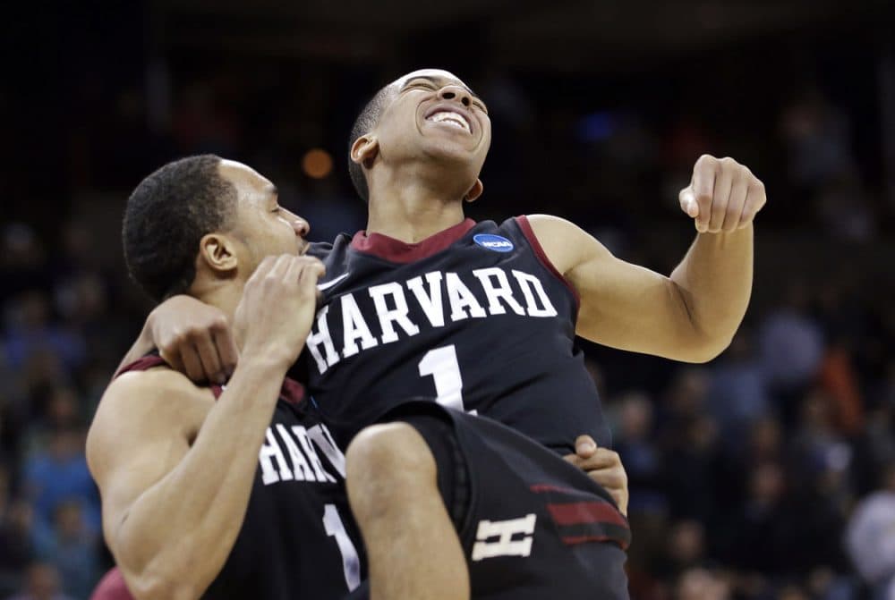 Harvard's Siyani Chambers, right, leaps into the arms of teammate Brandyn Curry after the team beat Cincinnati. (Elaine Thompson/AP)