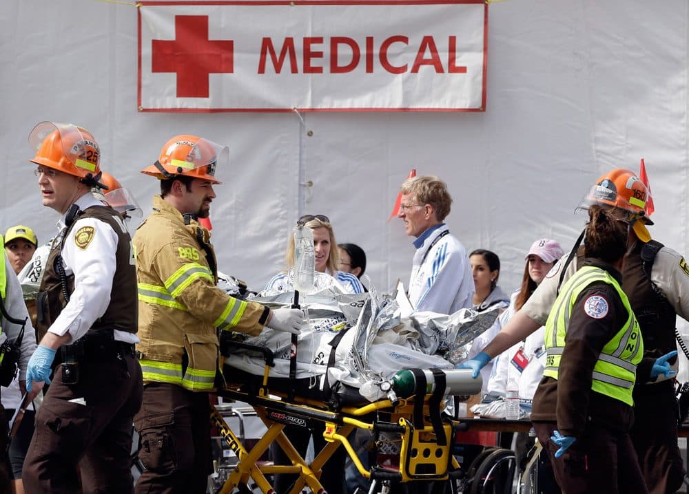Medical personnel work outside the medical tent after the Boston Marathon bombing on April 15, 2013. (Elise Amendola/AP)