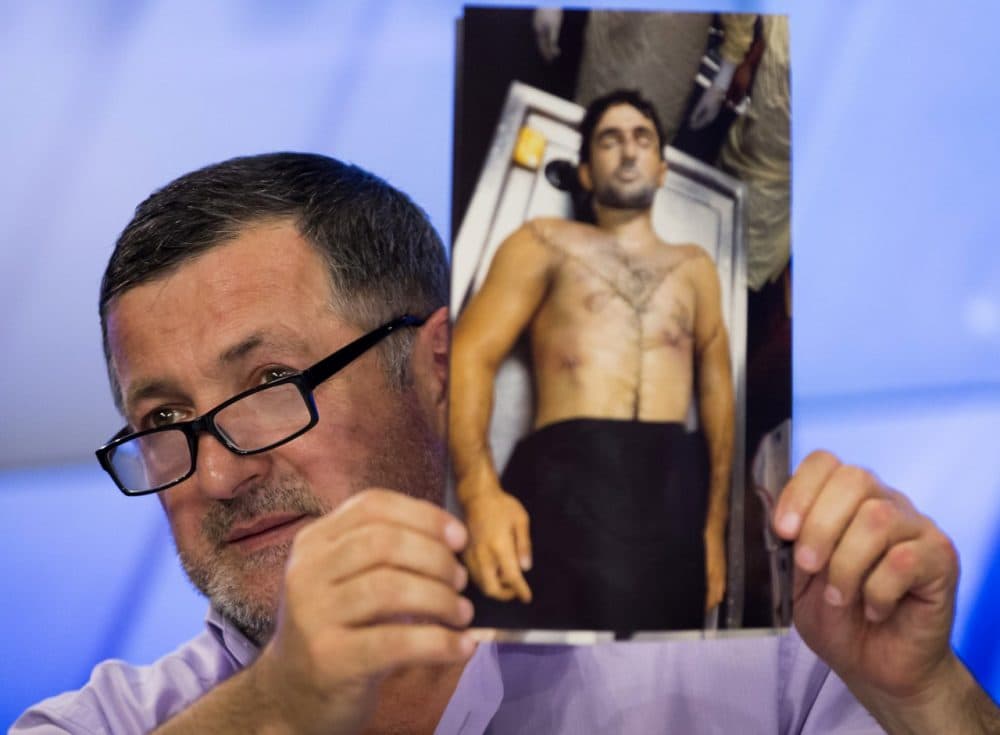 Abdul-Baki Todashev holds a photo he claims is of his dead son Ibragim Todashev. (Alexander Zemlianichenko/AP)