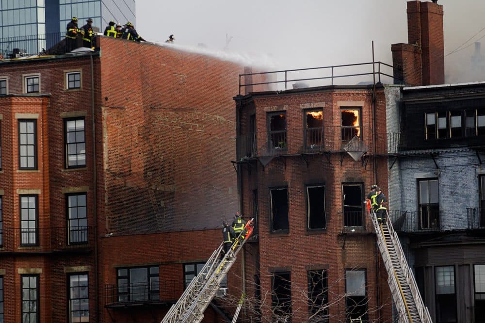 The Wednesday afternoon fire killed two firefighters and left 13 others injured. 