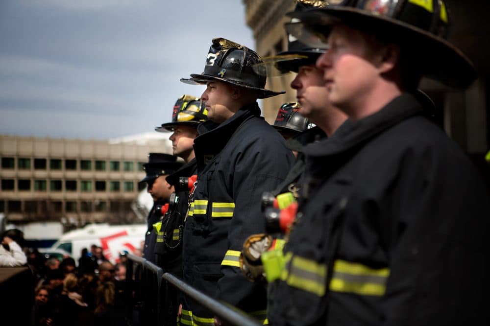 Hundreds gathered on City Hall Plaza Friday afternoon to honor two fallen firefighters. (Jesse Costa/WBUR)