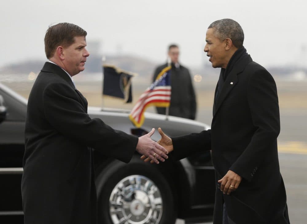 President Barack Obama, right, is greeted on the tarmac by Boston Mayor Mayor Martin Walsh, left, during his arrival on Air Force One at Boston Logan International Airport, Wednesday, March 5, 2014. Obama traveled to Boston this evening to attend a pair of Democratic fundraisers. (AP)