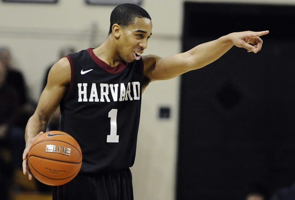 Harvard's Siyani Chambers, points and smiles at his team as he dribbles in the final seconds of an NCAA college basketball game against Yale, Friday, March 7, 2014, in New Haven, Conn. Harvard won 70-58. (AP)