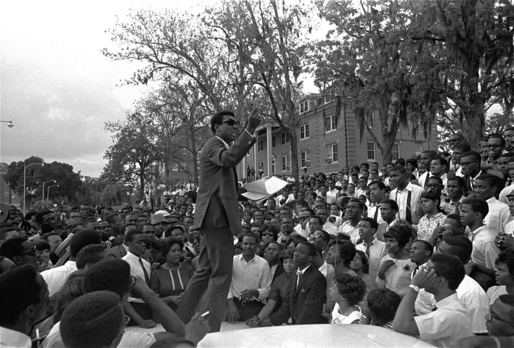 Stokely Carmichael, national head of the Student Nonviolent Coordinating Committee speaks from the hood of an automobile on the campus of Florida A&amp;M University, April 16, 1967, in Tallahassee, Florida. Several hundred students listened as Carmichael spoke of &quot;Black Power&quot; and the Vietnam war. (AP)