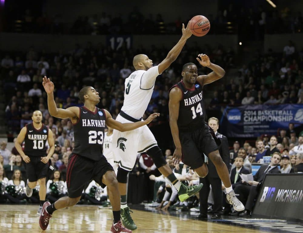 Michigan State’s Adreian Payne (5) fights for a loose ball against Harvard’s Wesley Saunders (23) and Steve Moundou-Missi (14) during the third-round game of the NCAA men's college basketball tournament in Spokane, Wash., Saturday, March 22, 2014. (Young Kwak/AP)