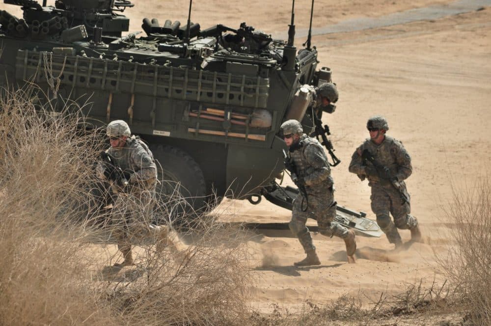 US Army troops run out of a Stryker armored vehicle as part of a military exercise. (AP/Dinesh Gupta)