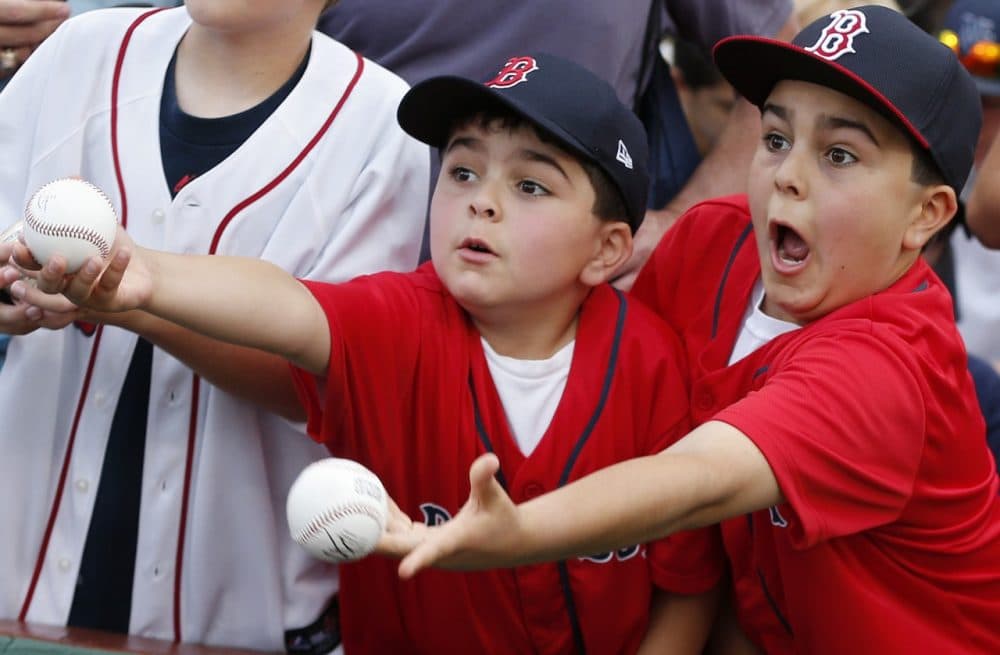 Young fans vie for autographs before a doubleheader between the Boston Red Sox and the Los Angeles Angels in 2013. (AP/Michael Dwyer)