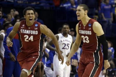 Stanford's Josh Huestis, left, and Dwight Powell, right, celebrate as Kansas' Tarik Black (25) watches in the background after in a third-round game of the NCAA college basketball tournament Sunday, March 23, 2014, in St. Louis. Stanford won 60-57. (AP)