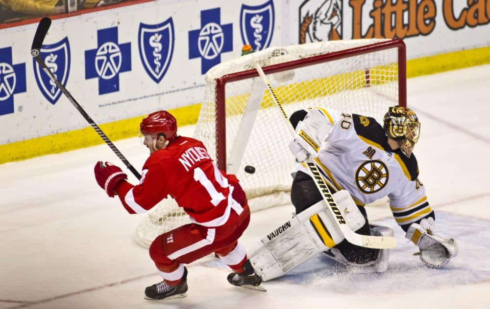 Detroit Red Wings forward Gustav Nyquist (14) scores the game-winning goal against Boston Bruins goalie Tuukka Rask (40), of Finland, during the third period of Wednesday's game in Detroit, Mich. The Red Wings won 3-2. (AP Photo/Tony Ding)
