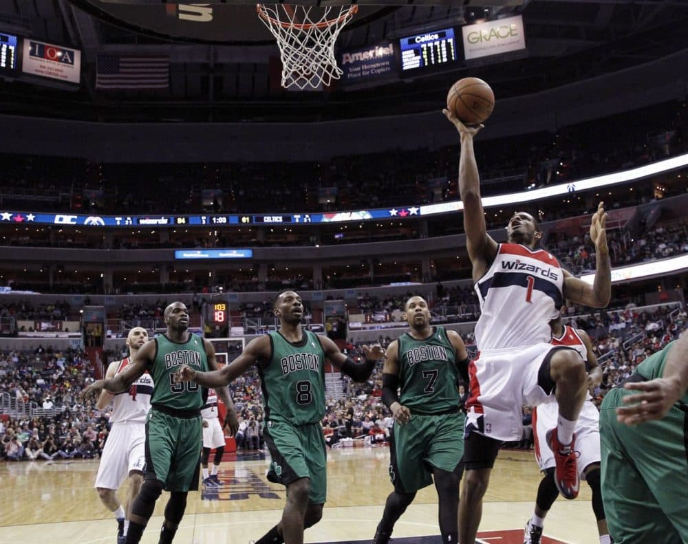 Washington Wizards forward Trevor Ariza (1) shoots in front of Boston Celtics center Joel Anthony (50), forward Jeff Green (8) and center Jared Sullinger (7) during the second half of an NBA basketball game Wednesday, in Washington. (AP Photo/Alex Brandon)
