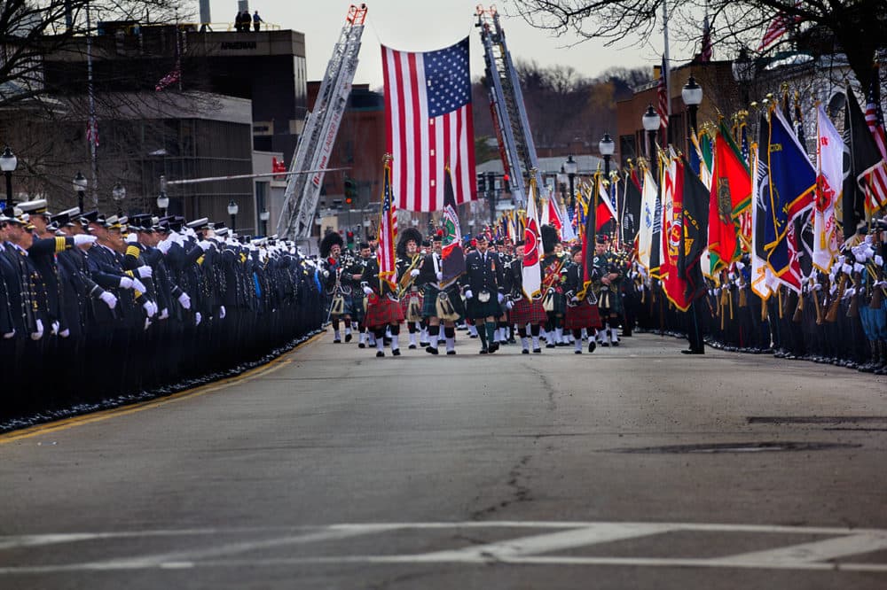 The funeral procession works its way down Main Street in Watertown. (Jesse Costa/WBUR)