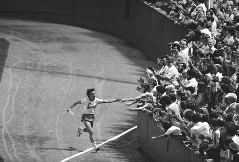David McGillivray reaches out to excited fans at Fenway Park in Boston on Tuesday, August 29, 1978, as he completes an 80-day cross country run some 3,400 miles to raise cash pledges for children's cancer research. (Maury/AP)