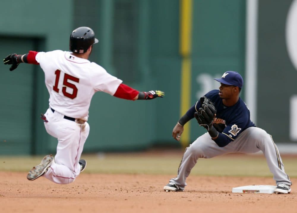 Milwaukee Brewers' Jean Segura waits for the throw as Boston Red Sox's Dustin Pedroia (15) attempts to steal second base in the sixth inning of a baseball game in Boston, Friday, April 4, 2014. Pedroia was out on the play.  (Michael Dwyer/AP)