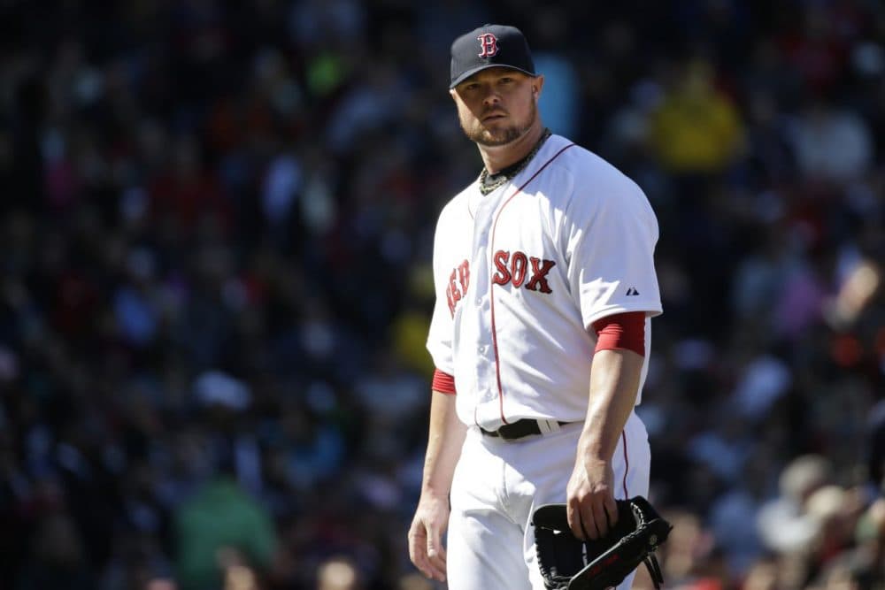 Boston Red Sox starting pitcher Jon Lester steps off the mound after giving up runs to the Milwaukee Brewers in the second inning. (Steven Senne/AP)
