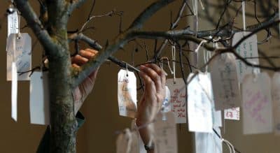 The anniversary of the Marathon may make people feel as if it's time for closure, but the truth is each person recovers from loss at a different pace. In this photo, a woman hangs a tag on a message tree at an exhibit entitled &quot;Dear Boston: Messages from the Marathon Memorial&quot; at the Boston Public Library in Boston, Monday, April 7, 2014. (Elise Amendola/AP) 